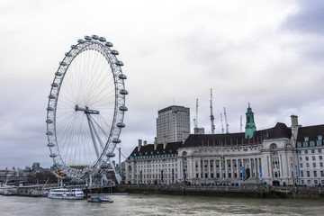 Fototapeta na wymiar The London Eye is a giant Ferris wheel on the South Bank of the River Thames in London. The structure is 443 feet (135 m) tall and the wheel has a diameter of 394 feet (120 m)