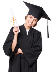 Portrait of graduate little girl student in black graduation gown with hat, holding diploma - isolated on white background. Child back to school and educational concept.