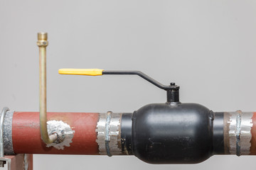 A heating system unit against a gray wall.