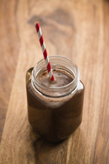 warm cocoa in jar mug on a wooden table
