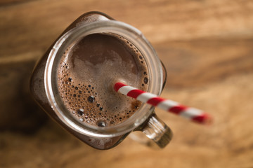 warm cocoa in jar mug on a wooden table