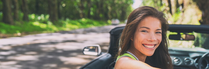 Asian car driver woman smiling happy relaxing in convertible car on summer road trip vacation....