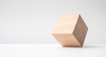 Design concept - abstract geometric real wooden cube with surreal layout on white floor background and it's not 3D render