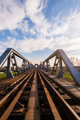 Fototapeta na wymiar Old iron railroad bridge in remote rural area in Europe