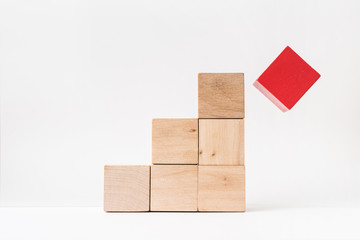 Business and design concept - abstract geometric real wooden cube pyramid on white floor background and it's not 3D render. It's the symbol of make a mistake, fall into a trap