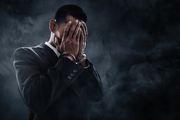 Businessman in handcuffs