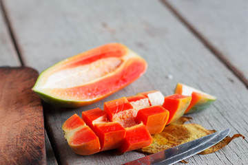 Papaya sliced on wooden floor.