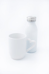 White cup with a white thermo bottle on a white background