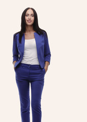 Confident young businesswoman standing with hands in pocket, loo