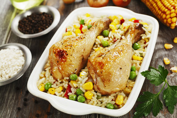 Chicken legs baked with rice and vegetables