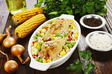 Chicken legs baked with rice and vegetables