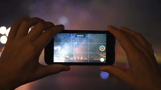 Hands Taking Photos By Smart Phone Of Fireworks Display Celebration