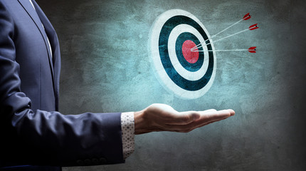 Businessman shows archery target with arrows. 3d rendering.