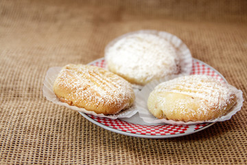 Three Homemade or table food cookies on white plate with burlap textile. Close up shot.