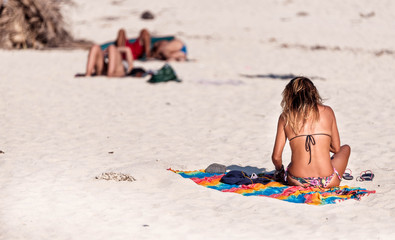 A girl was sunbathing on the white sand beach