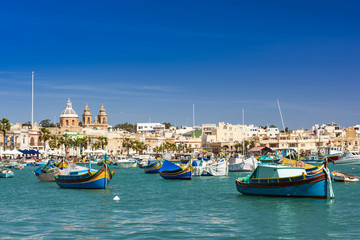 Fototapeta na wymiar Colorful painted fishing boats in Marsaxlokk,Malta