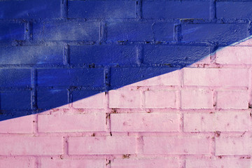 Colorful (pink and blue) painted brick wall as background, texture