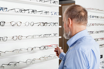 Elderly man in optics store