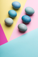 Happy Easter pastel coloured background. Hand painted Easter eggs abstract minimal concept.