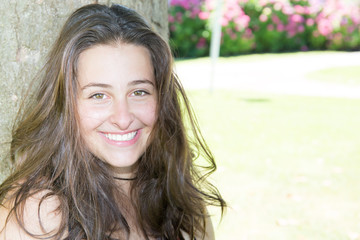 Portrait of a beautiful young teenager girl in summer green garden park