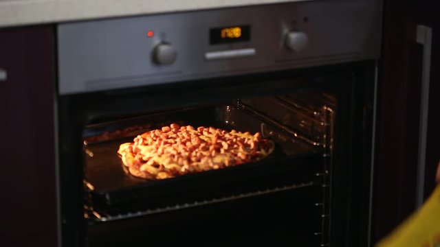 semi-finished pizza put in the oven for cooking.