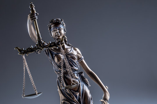 Statute of Justice. Bronze statue Lady Justice holding scales and sword