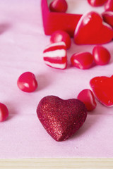 gift box with heart candies on pink background