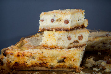 closeup two pieces of cheesecake stands on whole pie