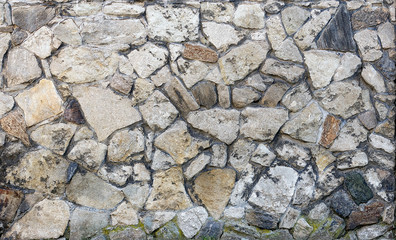 Texture of the wall of stones of different shapes