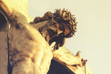 Jesus Christ in a crown of thorns, crucifixion. The concept of faith in God - obrazy, fototapety, plakaty