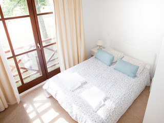Modern elegant hotel bedroom interior in summer day