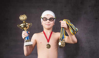 Little boy celebrates his golden trophy in swimming © rodjulian
