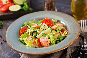 Healthy salad with fish. Baked salmon, tomatoes, lime and lettuce. Healthy dinner.