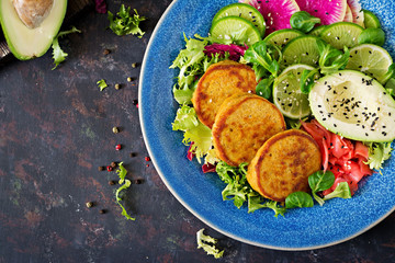 Vegan buddha bowl dinner food table. Healthy food. Healthy vegan lunch bowl. Fritter with lentils and radish, avocado salad. Flat lay. Top view