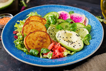 Vegan buddha bowl dinner food table. Healthy food. Healthy vegan lunch bowl. Fritter with lentils and radish, avocado salad