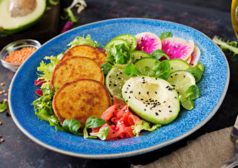 Vegan buddha bowl dinner food table. Healthy food. Healthy vegan lunch bowl. Fritter with lentils and radish, avocado salad