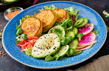 Vegan buddha bowl dinner food table. Healthy food. Healthy vegan lunch bowl. Fritter with lentils and radish, avocado salad