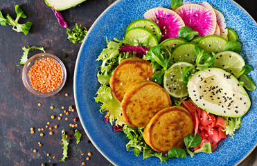 Vegan buddha bowl dinner food table. Healthy food. Healthy vegan lunch bowl. Fritter with lentils and radish, avocado salad. Flat lay. Top view