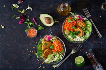 Fototapeta na wymiar Vegan buddha bowl dinner food table. Healthy food. Healthy vegan lunch bowl. Fritter with lentils and radish, avocado, carrot salad. Flat lay. Top view