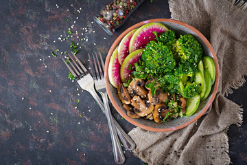 Vegan buddha bowl dinner food table. Healthy food. Healthy vegan lunch bowl. Grilled mushrooms, broccoli, radish salad. Flat lay. Top view.