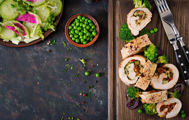 Chicken roll with stuffed sun-dried tomatoes and cheese. Flat lay. Top view