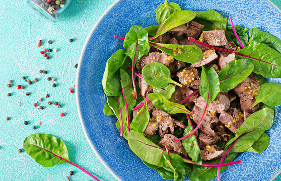 Salad of chicken liver and leaves of spinach and chard. Flat lay Top view