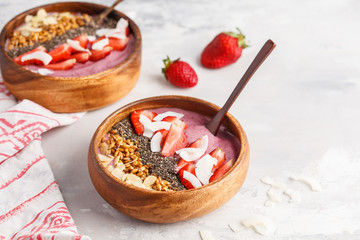 Vegan breakfast concept. Strawberry smoothie bowl with almonds, chia, sprouts and coconut.