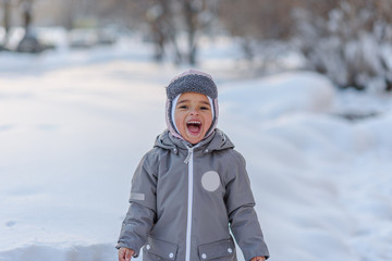 Cute child playing with snow