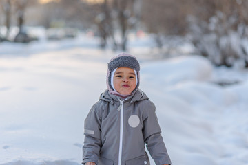 Cute child playing with snow