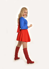 full length portrait of pretty girl wearing super hero costume, standing pose, isolated on white studio background.