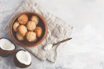 Healthy vegan homemade coconut cookies in wooden bowl, top view, light background. Healthy vegan food concept.