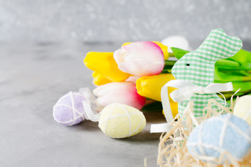Easter composition with bunny, eggs and tulips.