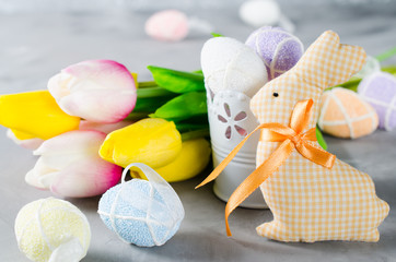 Easter composition with bunny, eggs and tulips.