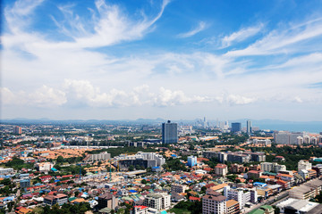 Fototapeta na wymiar Morning cityscape with high pamoram view of Pattaya from Unixx condo. Modern buildings. High panorama with blue sky and clouds.